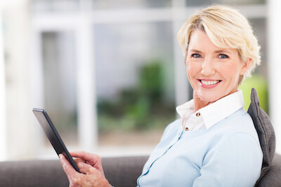 Woman on tablet smiling